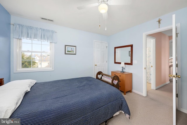 bedroom with visible vents, light carpet, baseboards, and ceiling fan