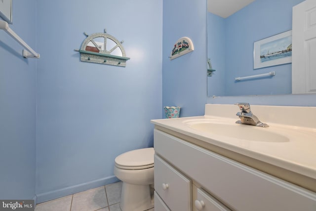 bathroom featuring vanity, tile patterned floors, and toilet