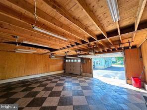 garage with wooden walls and wooden ceiling