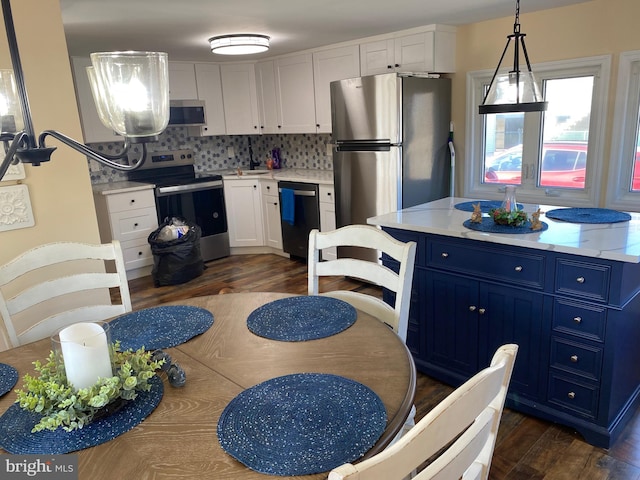 kitchen featuring blue cabinets, dark wood finished floors, white cabinetry, appliances with stainless steel finishes, and light countertops