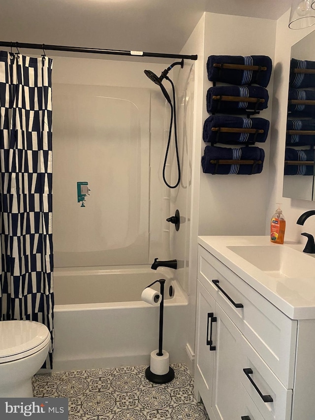 bathroom with tile patterned floors, toilet, shower / bath combo with shower curtain, and vanity