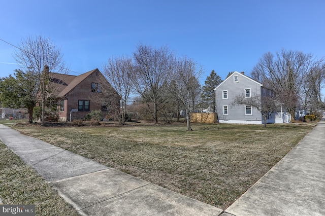 view of property exterior featuring a yard and a chimney