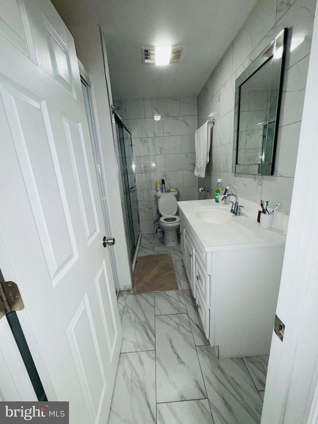 531 E Luray St, Philadelphia, PA 19120 - bathroom featuring a shower stall, toilet, vanity, marble finish floor, and tile walls