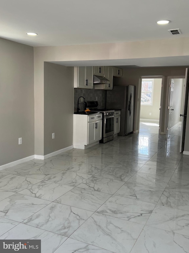 kitchen with visible vents, marble finish floor, under cabinet range hood, appliances with stainless steel finishes, and baseboards