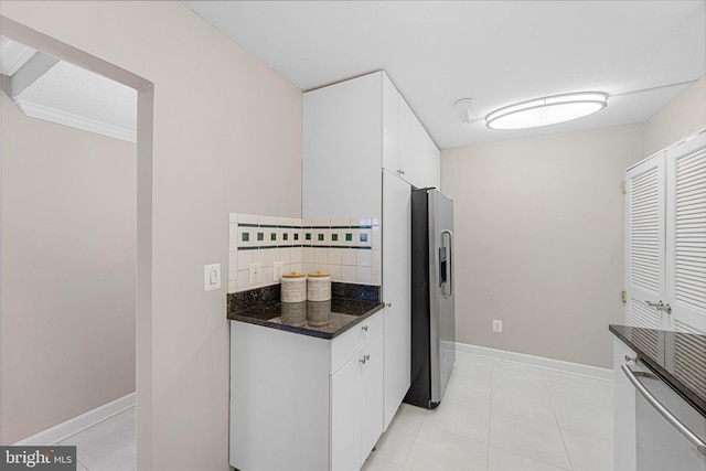 kitchen with white cabinetry, light tile patterned floors, backsplash, and appliances with stainless steel finishes