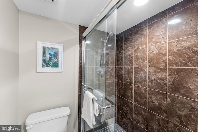 full bathroom with a stall shower and toilet