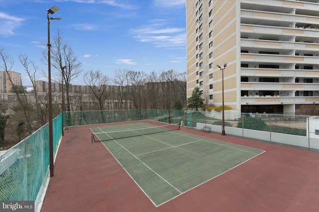 view of sport court with fence