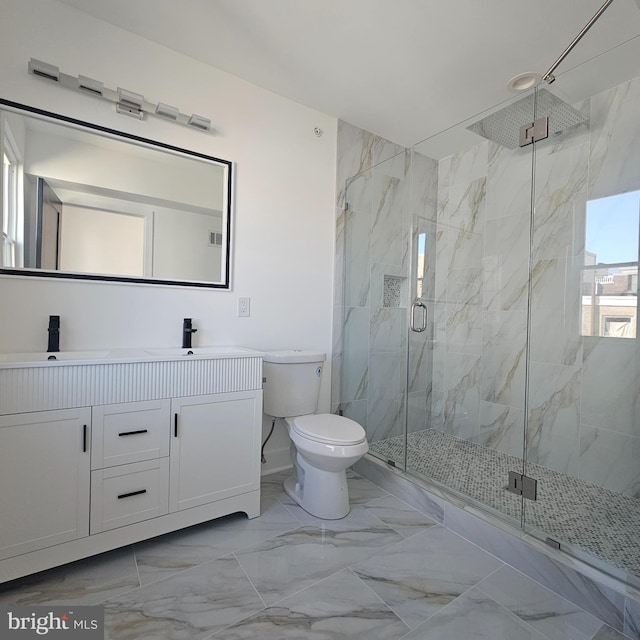 bathroom with a marble finish shower, marble finish floor, toilet, and a sink