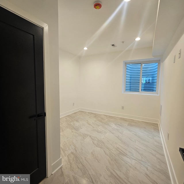 empty room with recessed lighting, visible vents, baseboards, and marble finish floor