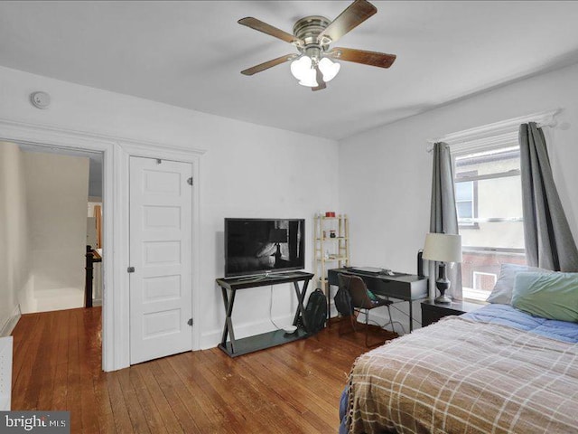 bedroom with baseboards, ceiling fan, and hardwood / wood-style flooring