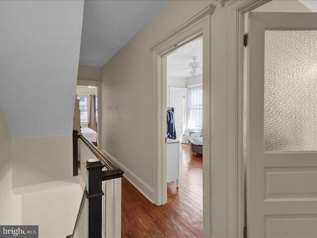 stairs featuring baseboards and hardwood / wood-style flooring