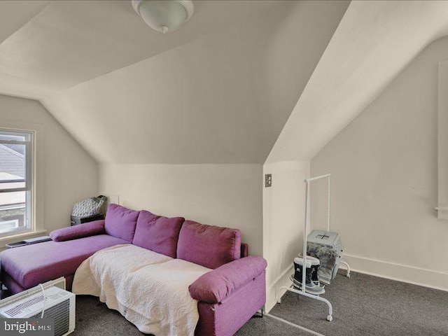 interior space with baseboards, carpet flooring, and lofted ceiling