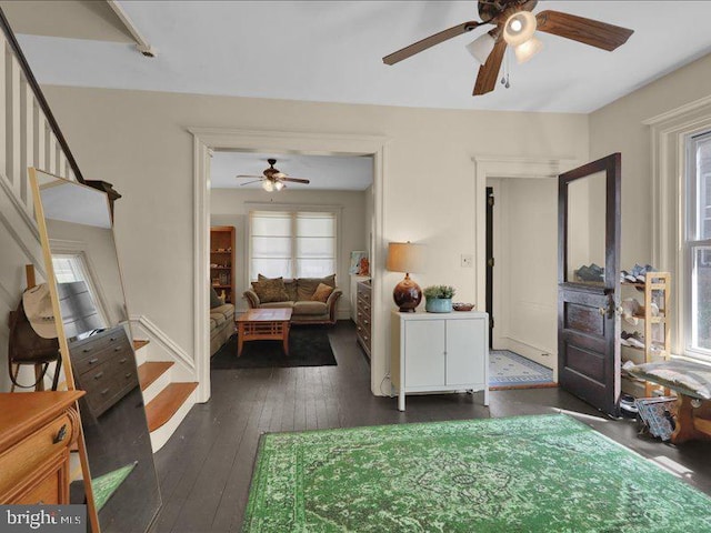 bedroom featuring a ceiling fan and dark wood-style floors