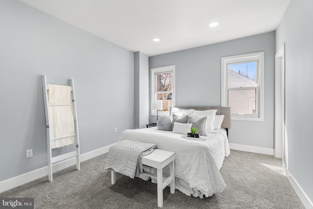 carpeted bedroom featuring recessed lighting, multiple windows, and baseboards