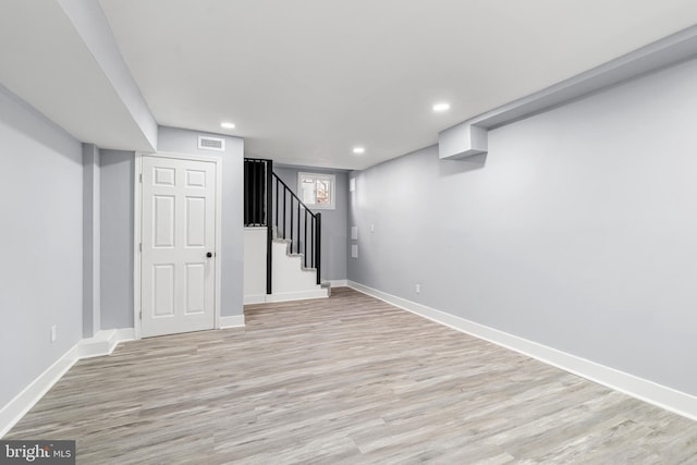 basement with recessed lighting, visible vents, light wood-style flooring, and stairs