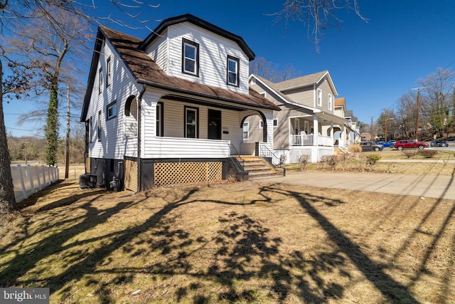 view of front of home featuring cooling unit, fence, and covered porch