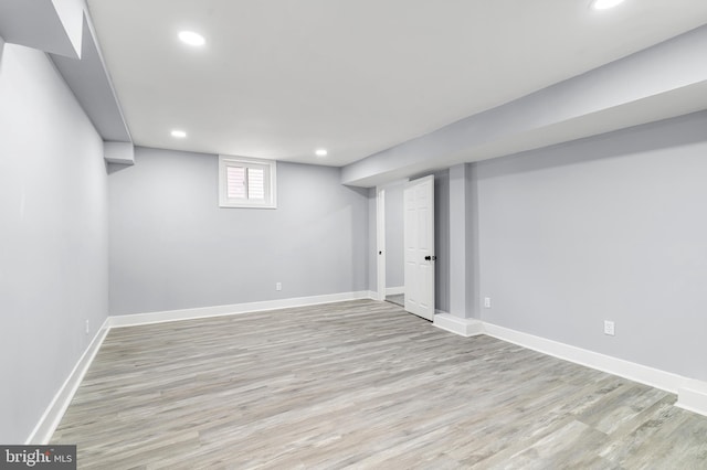 basement with recessed lighting, light wood-type flooring, and baseboards