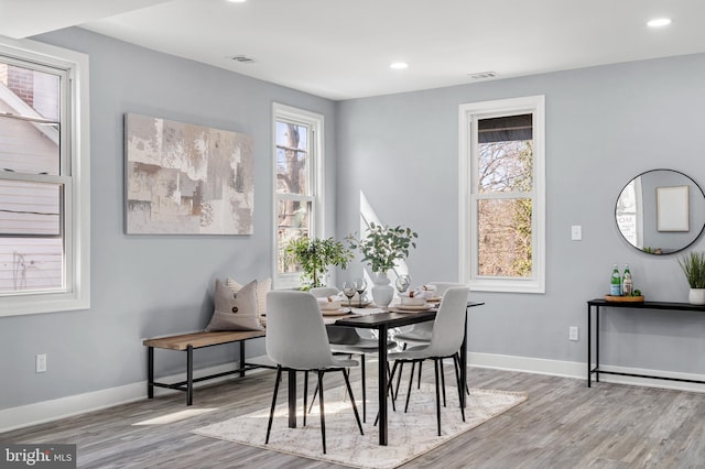 dining area with recessed lighting, baseboards, and wood finished floors