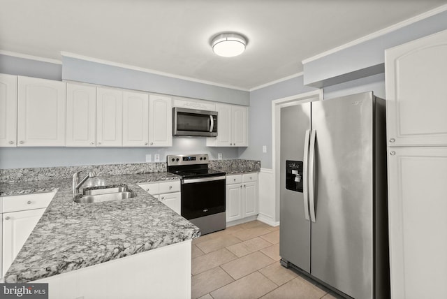 kitchen featuring light stone counters, ornamental molding, a sink, appliances with stainless steel finishes, and white cabinetry