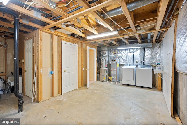 unfinished basement with water heater and washer and clothes dryer