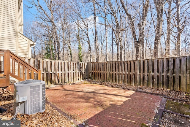 view of patio / terrace featuring central air condition unit and a fenced backyard