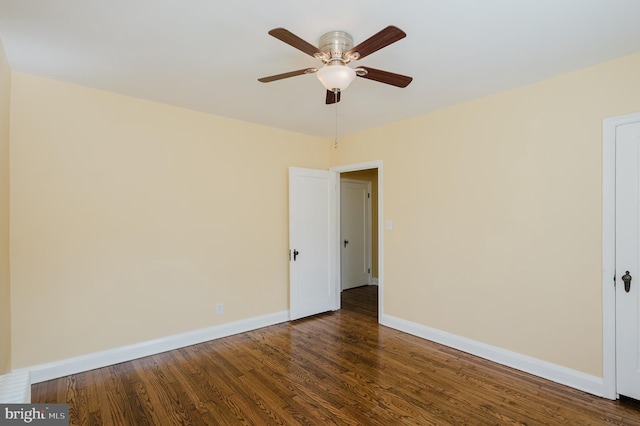 unfurnished room featuring ceiling fan, baseboards, and wood finished floors