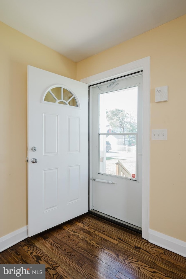 entrance foyer featuring dark wood-style floors and baseboards