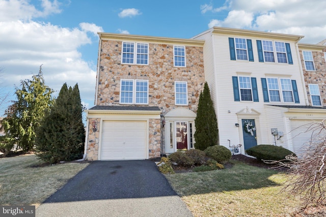 view of property with driveway, a front lawn, and a garage