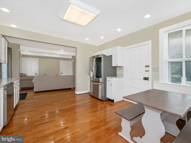 dining room featuring recessed lighting, light wood-type flooring, and baseboards