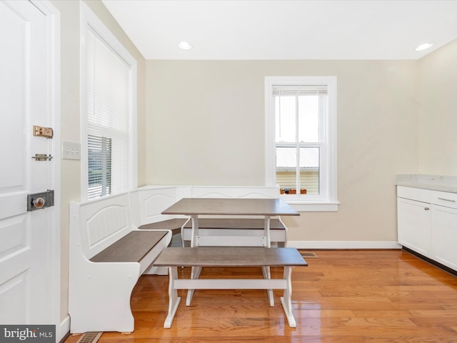 dining room with recessed lighting, breakfast area, light wood-type flooring, and baseboards