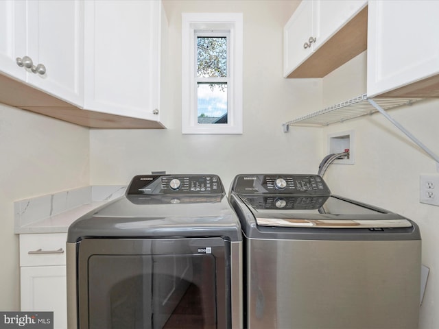 clothes washing area with cabinet space and independent washer and dryer