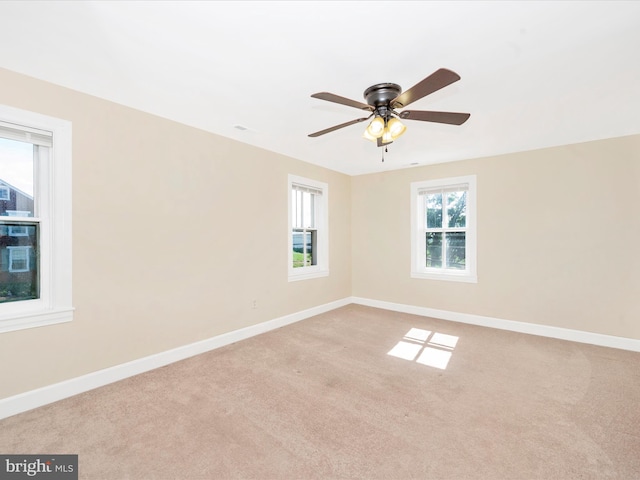 empty room with baseboards, ceiling fan, and carpet flooring