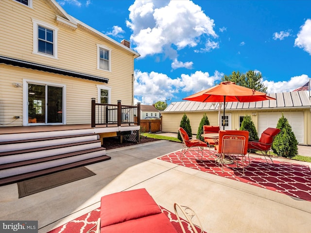 view of patio with a wooden deck and fence