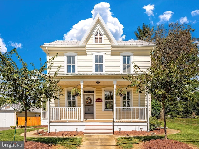 view of front of house featuring a porch and metal roof