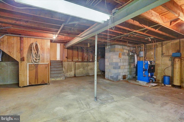 unfinished basement with a heating unit and heating fuel