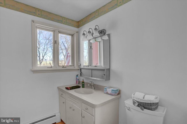 bathroom with baseboard heating, vanity, and toilet