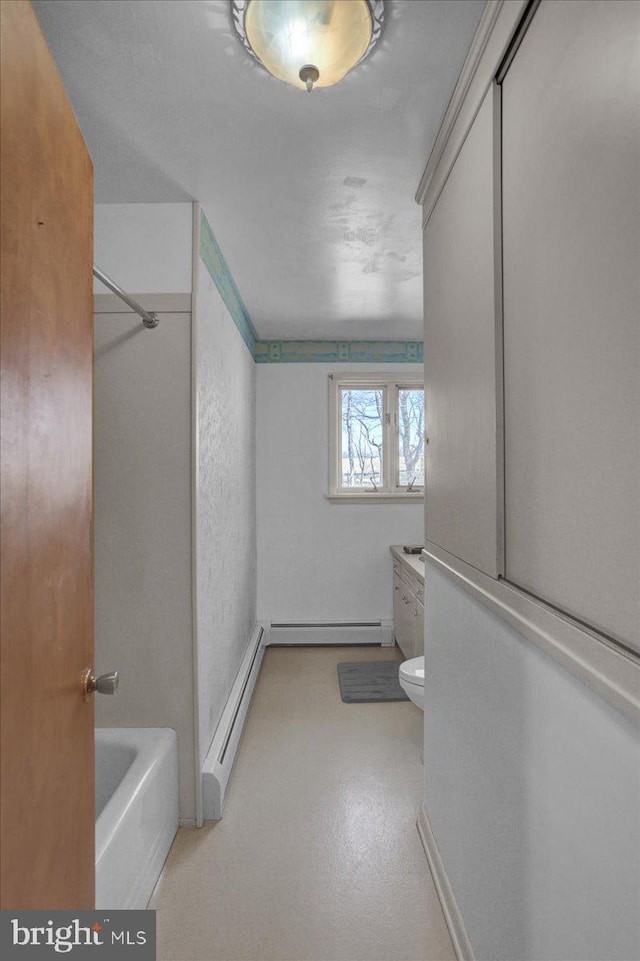 bathroom featuring a baseboard radiator, toilet, shower / bathtub combination, and a textured wall