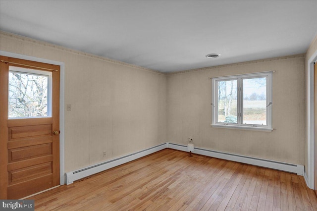 interior space featuring light wood-style floors, baseboard heating, and visible vents