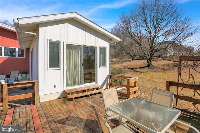 wooden deck featuring outdoor dining area