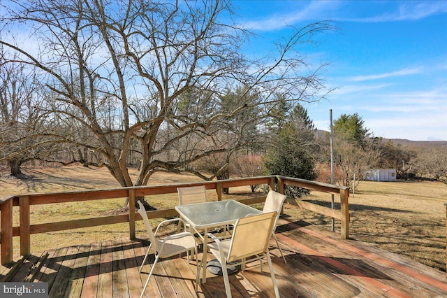 wooden deck featuring outdoor dining area