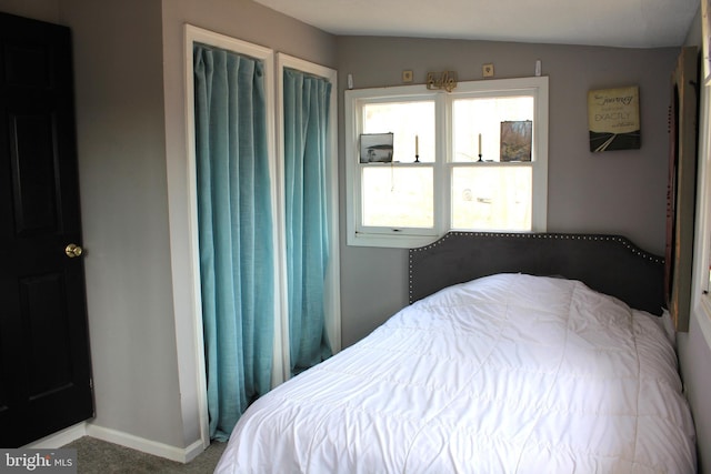 carpeted bedroom featuring baseboards