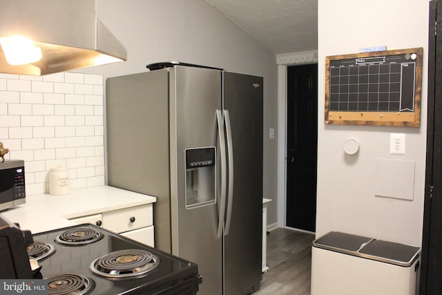 kitchen featuring wood finished floors, decorative backsplash, light countertops, appliances with stainless steel finishes, and a textured ceiling