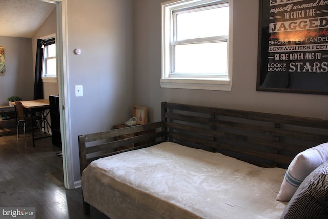 bedroom featuring vaulted ceiling and wood finished floors