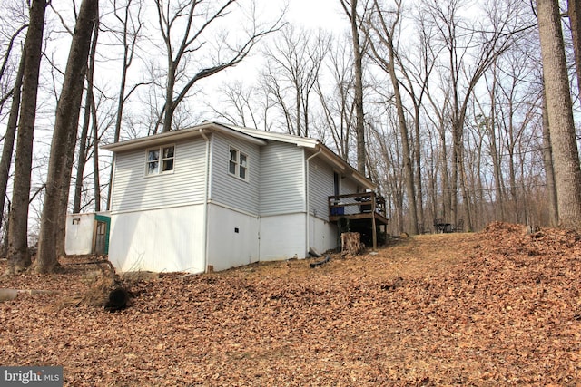 view of property exterior featuring a wooden deck