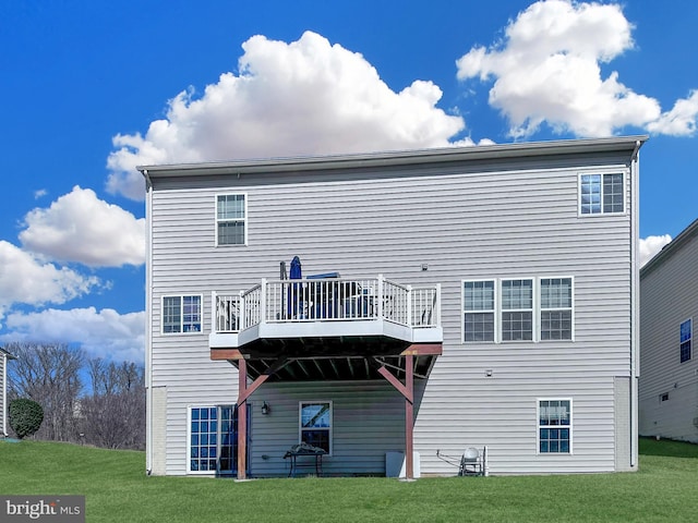 back of property featuring a deck and a yard