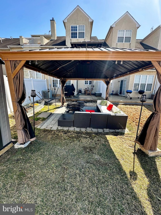 exterior space with a gazebo, a patio area, fence, and stucco siding