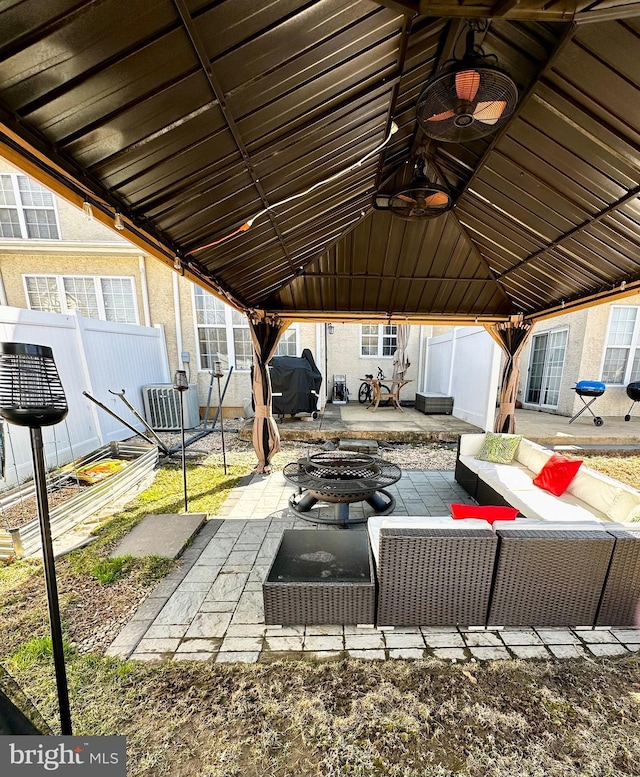 view of patio with a gazebo, fence, an outdoor living space, and a grill