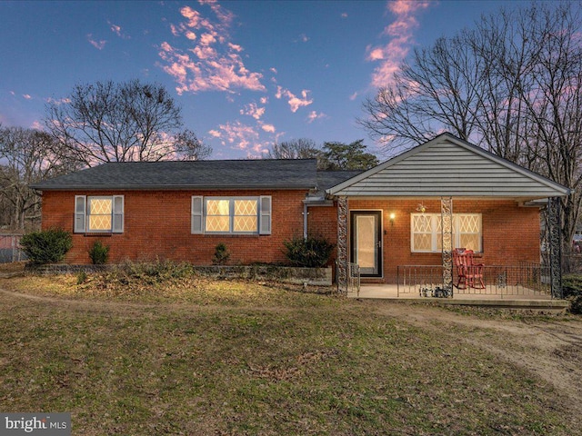 ranch-style house with brick siding and a front lawn