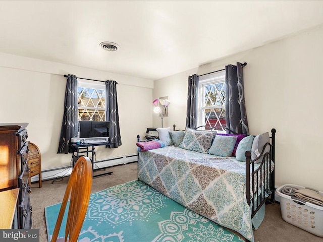 carpeted bedroom featuring visible vents and baseboard heating