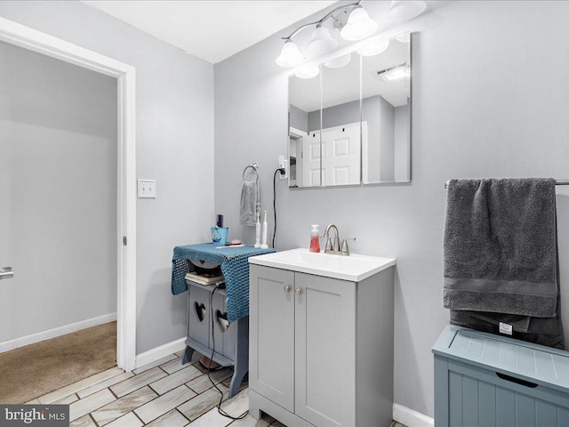 bathroom featuring baseboards and vanity